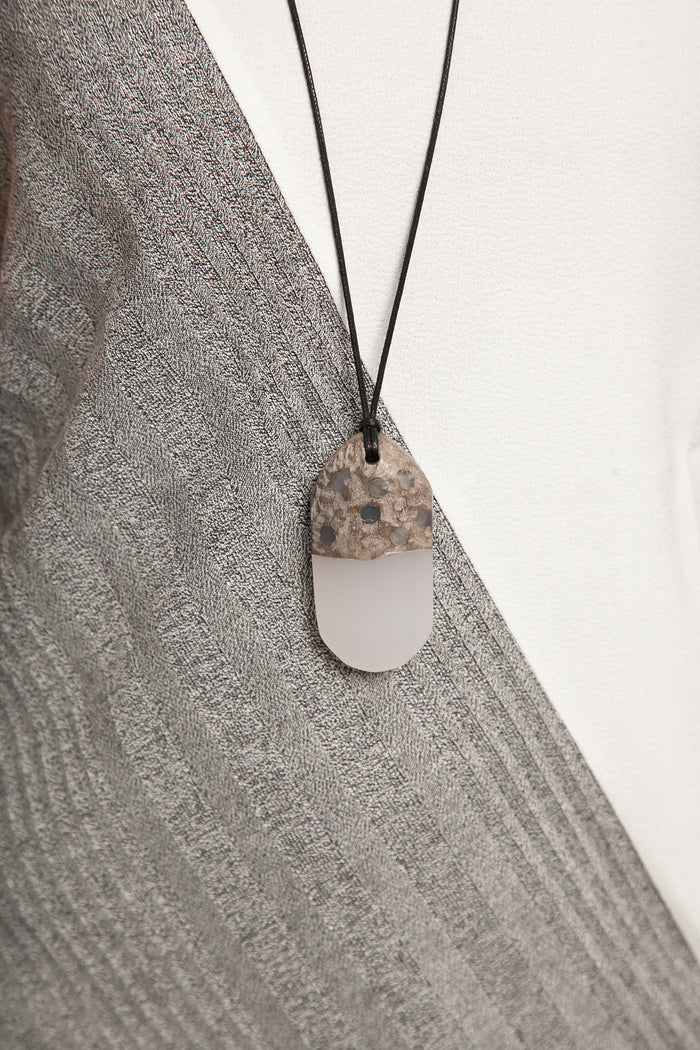 Geode inspired pendant necklace worn close up
