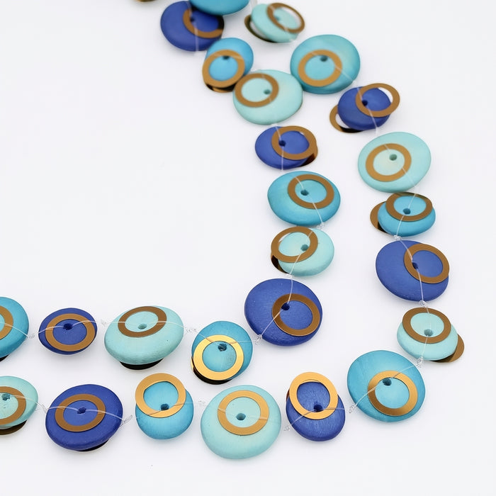 Necklace with blue and green circular beads on a white background