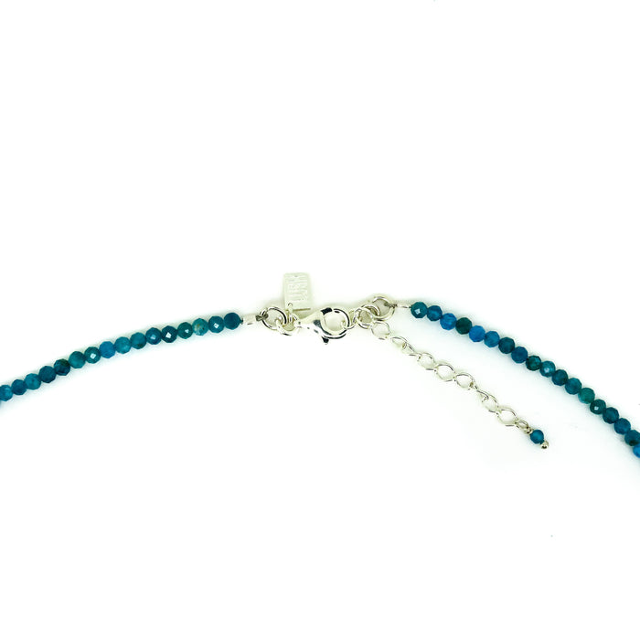 Blue beaded necklace with silver clasp on a white background