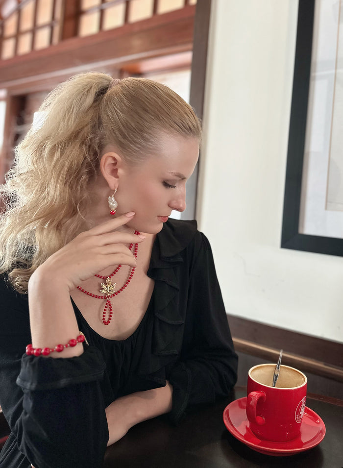 The unique, irregular shape of the pearls adds a touch of sophistication, while the coral hooks infuse a pop of color and playfulness.