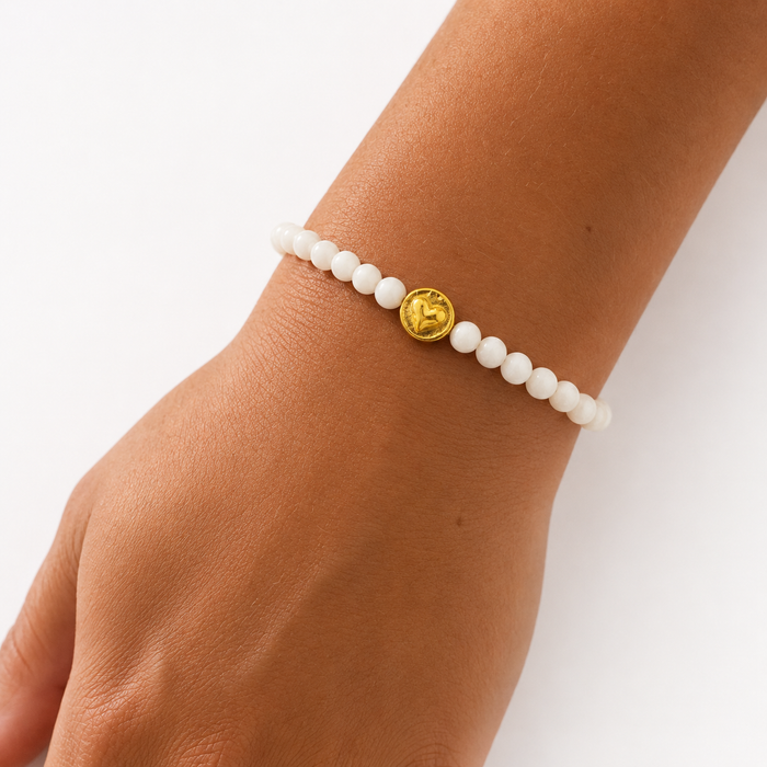 Beach Love Mother of Pearl Bracelet Gold featuring genuine mother of pearl beads, a polished gold heart charm, gold vermeil clasp, and adjustable chain.