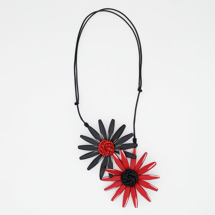 Necklace with black and red flower pendants on a white background