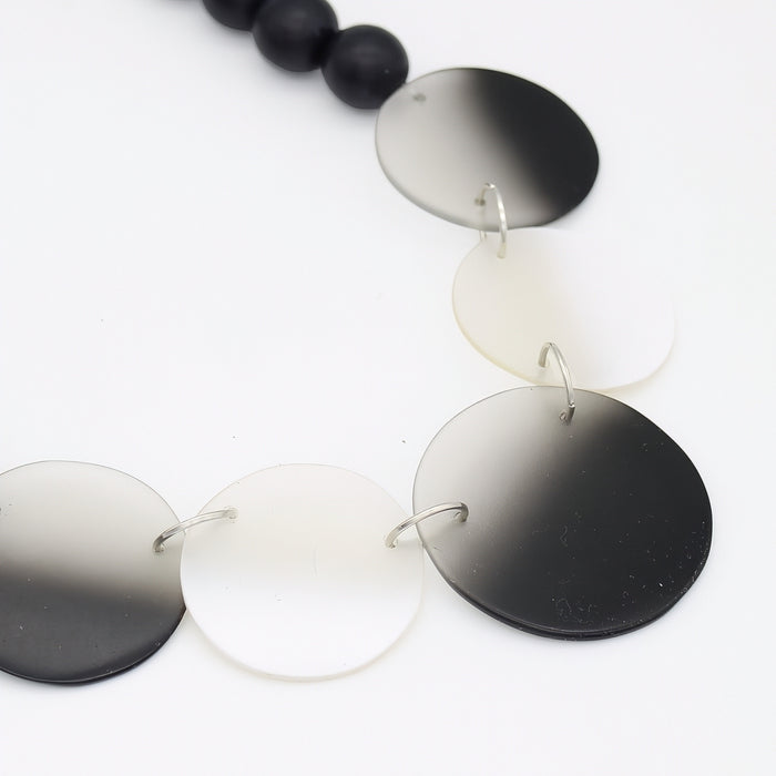 Necklace with round, gradient-colored pendants on a white background