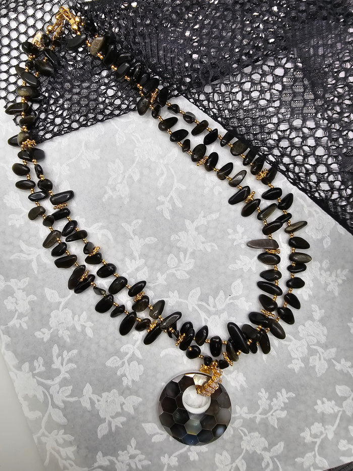 black obsidian necklace with shell pendant