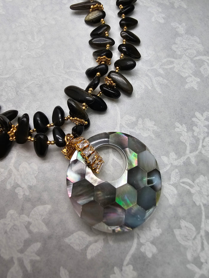 black obsidian necklace with shell pendant