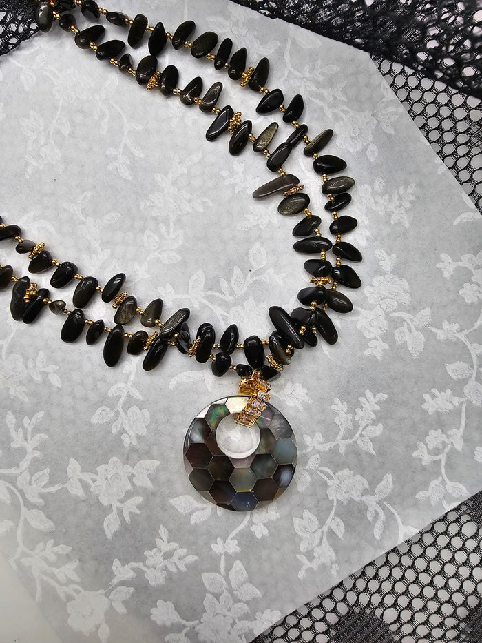 black obsidian necklace with shell pendant