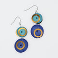 Earrings with circular design in blue, gold, and teal on a white background