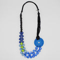 Necklace with blue, green, and black beads on a white background