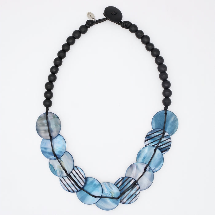 Necklace with black beads and blue circular beads on a white background