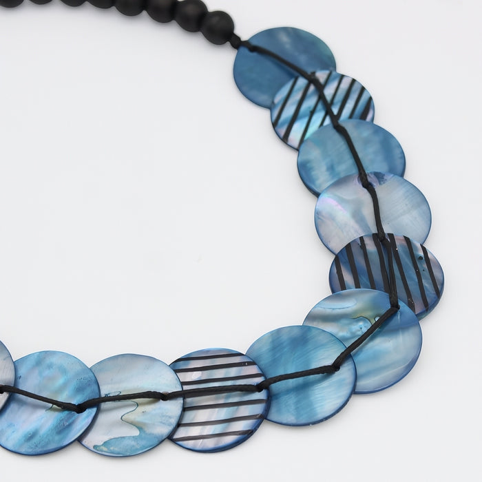 Necklace with blue and black patterned beads on a white background