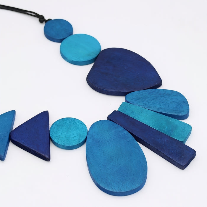 Blue geometric necklace on a white background