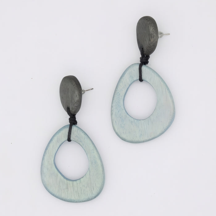 Pair of earrings with green and black circular designs on a white background