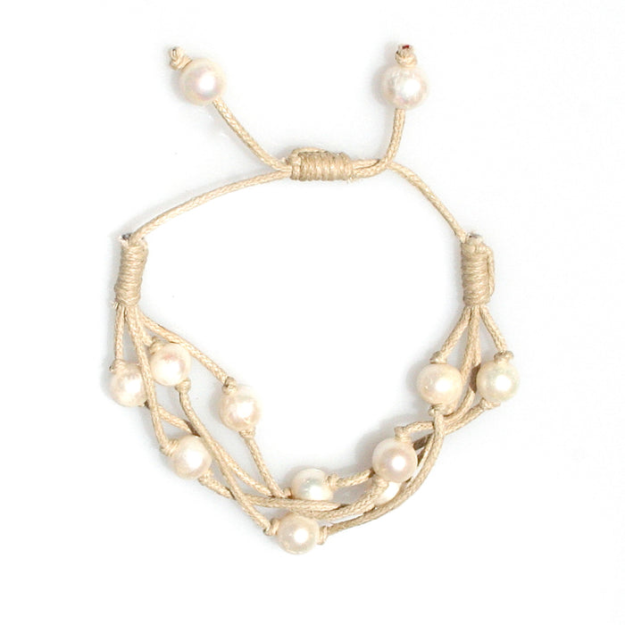 Close-up natural freshwater pearls on camel cord bracelet