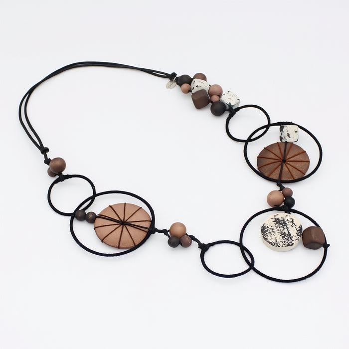Necklace with wooden and ceramic beads on a white background