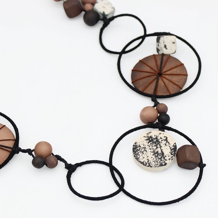 Necklace with wooden and stone beads on a white background