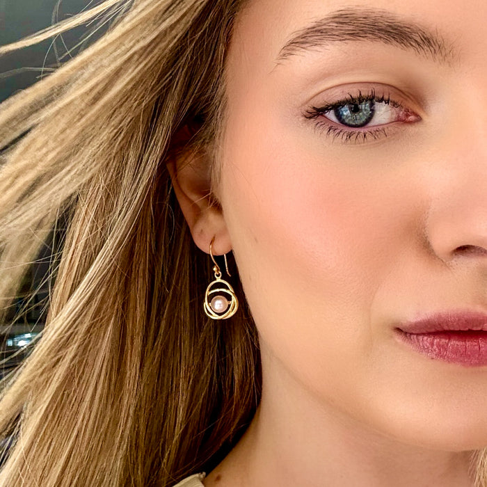 pink pearl earrings set in gold