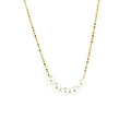 A gold chain necklace with five white pearls placed along the length, presented against a white background.