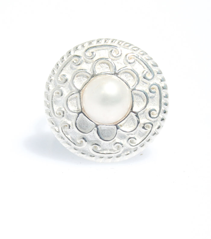 A sterling silver ring with a detailed circular design and a central white freshwater pearl, isolated on a white background.