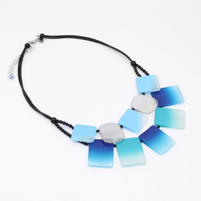 Necklace with blue and white gradient pendant on a white background