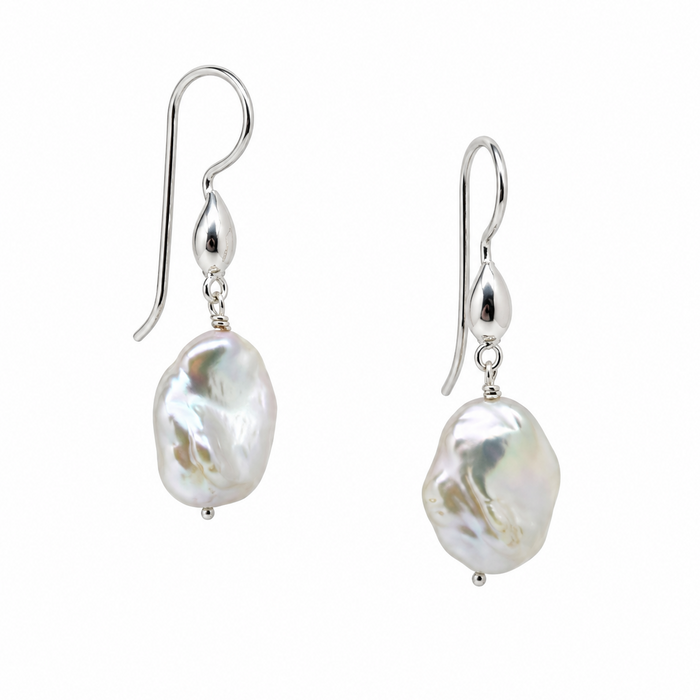 A pair of silver drop earrings featuring irregular, lustrous white baroque pearls suspended from silver French hook ear wires, shown against a plain white background.