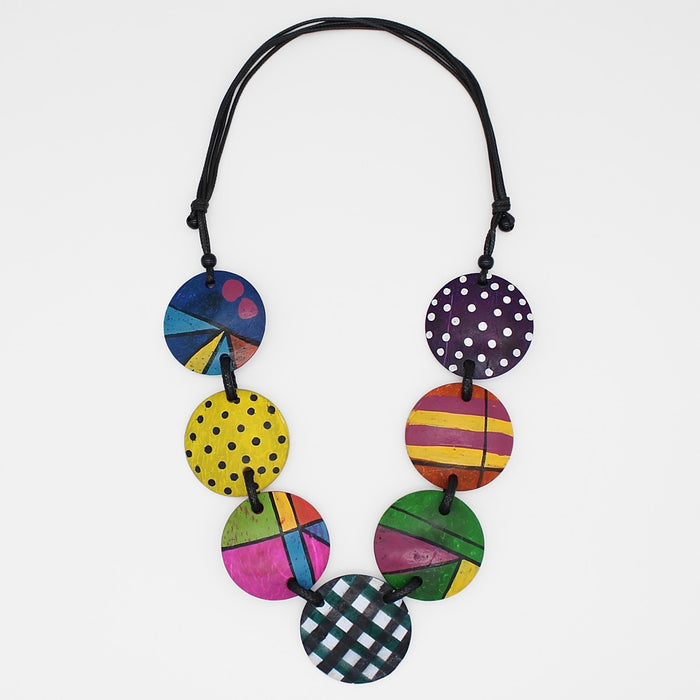Colorful necklace with patterned discs on a white background