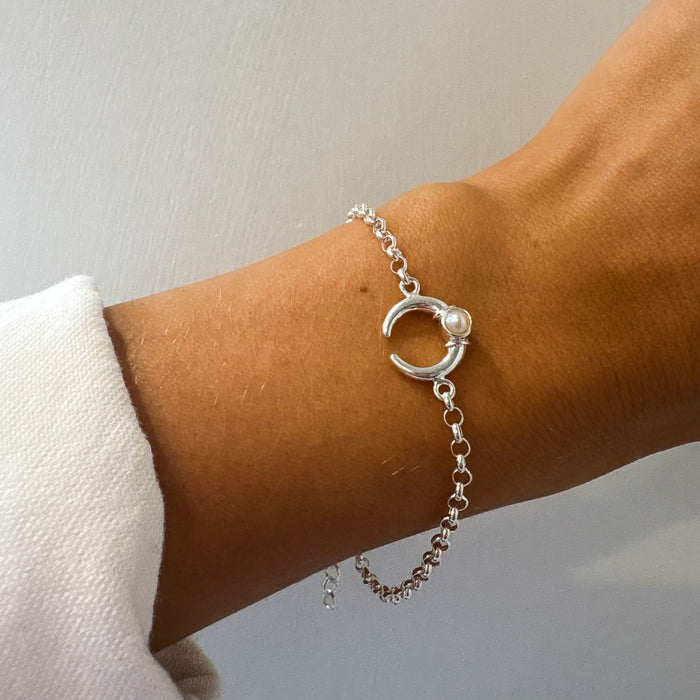 silver bracelet with a crescent shaped moon