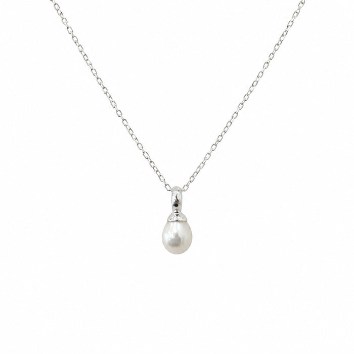 Dainty white freshwater pearl pendant necklace in sterling silver featuring a 9mm pearl on a fine silver chain