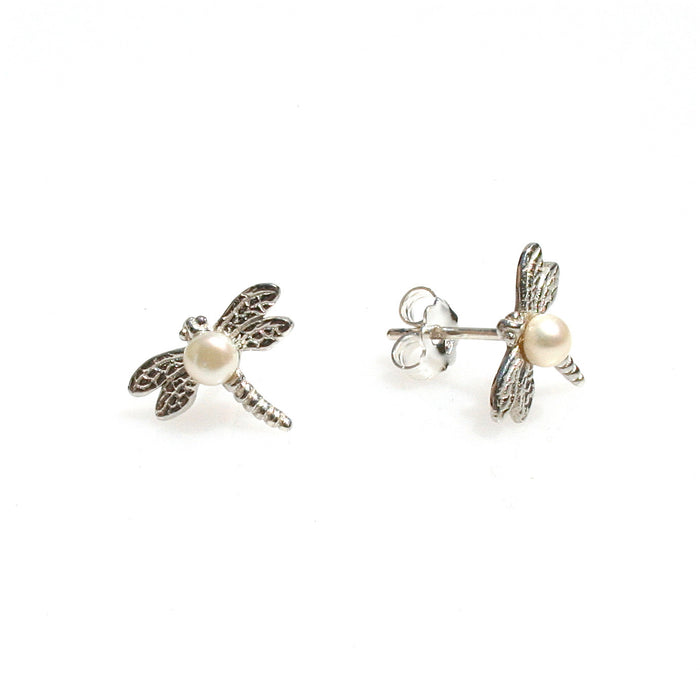 A pair of sterling silver dragonfly stud earrings with a freshwater pearl positioned in the center of each dragonfly's body.