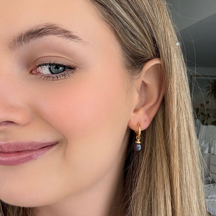 Gold sleeper earrings with black freshwater pearls designed in Broome Western Australia