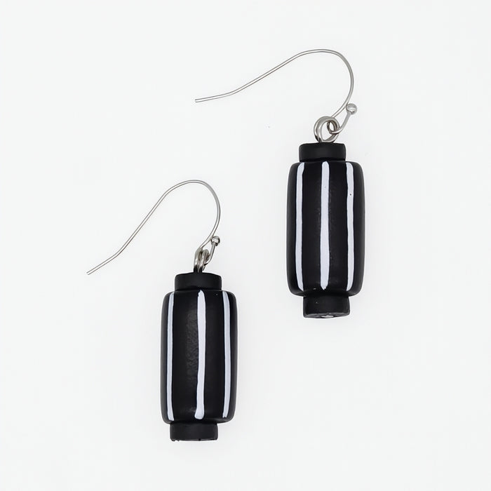A pair of black and white striped glass drop earrings with silver-tone fishhook wires, shown on a plain white background.