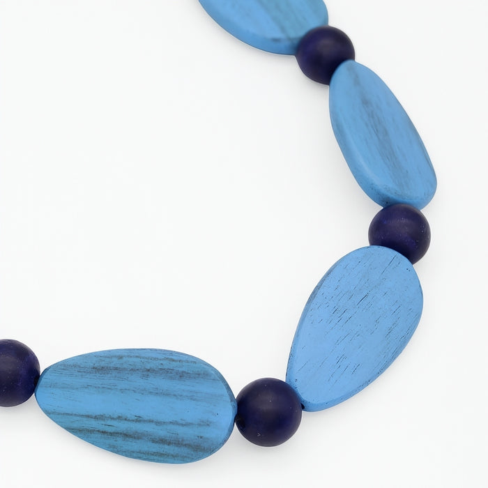 Necklace with blue and purple beads on a white background