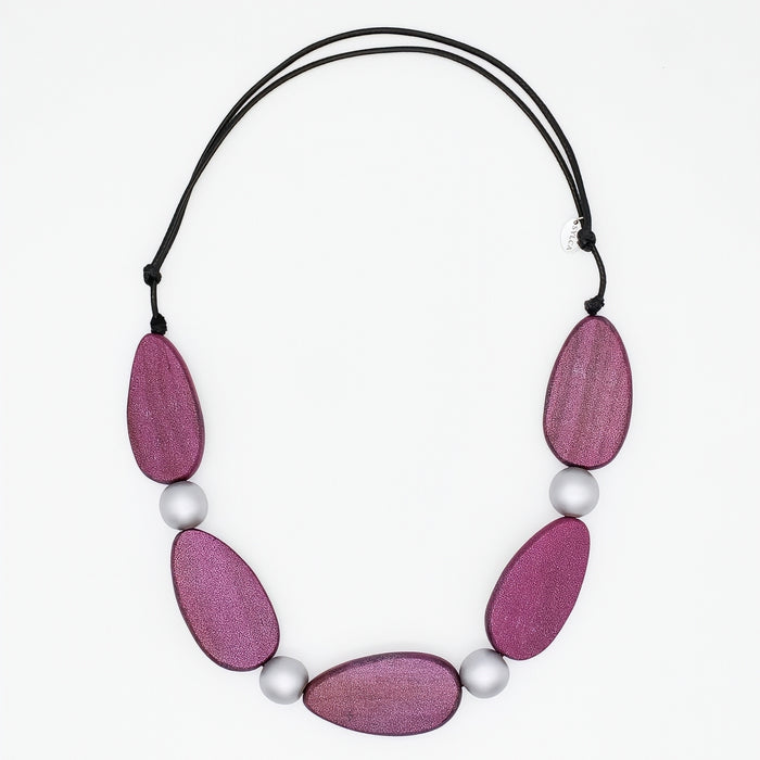 Necklace with pink wooden beads and white pearls on a white background