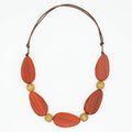 Necklace with orange and gold beads on a white background