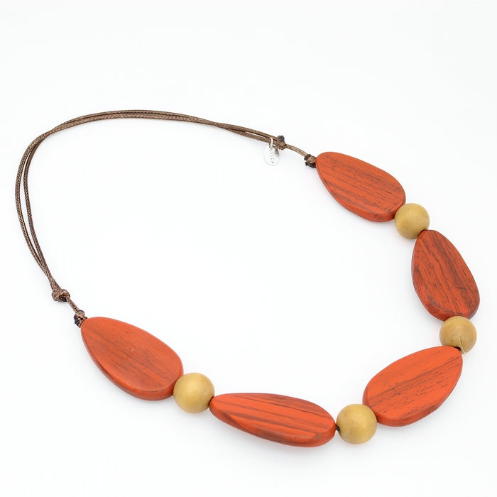 Necklace with orange and beige beads on a white background