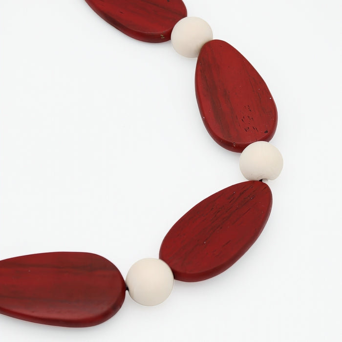 Necklace with red and white beads on a white background