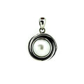 silver pendant with central pearl with swirls of silver reminscent of a sunset