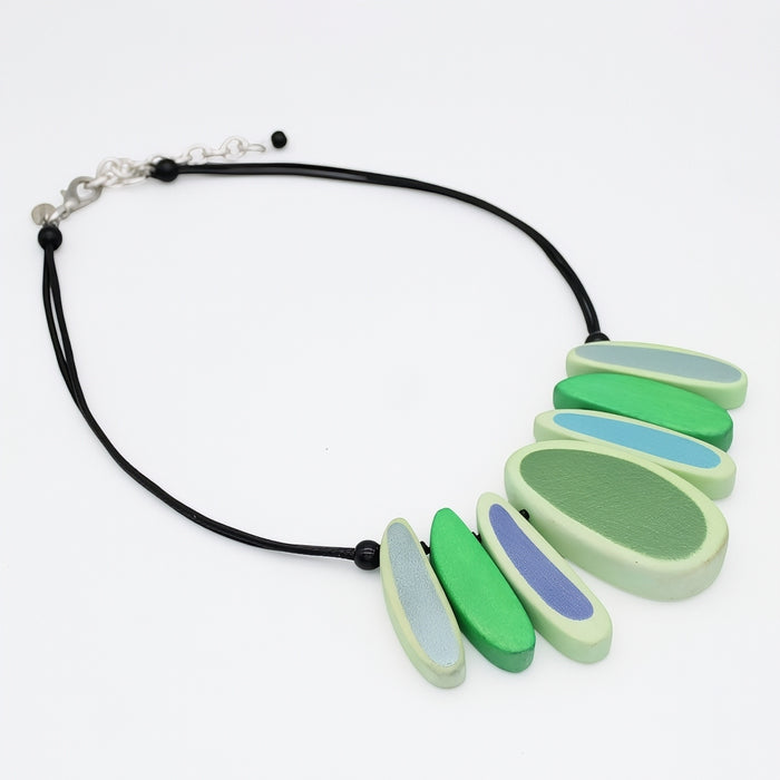 Necklace with green and blue pendant on a white background