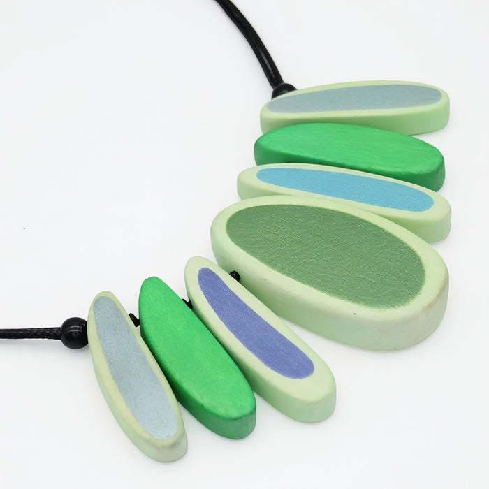 Necklace with green and blue oval beads on a white background