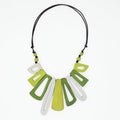 Necklace with green and white geometric pendants on a white background