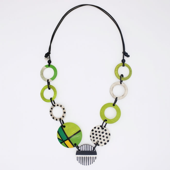 Necklace with green and white circular pendants on a white background