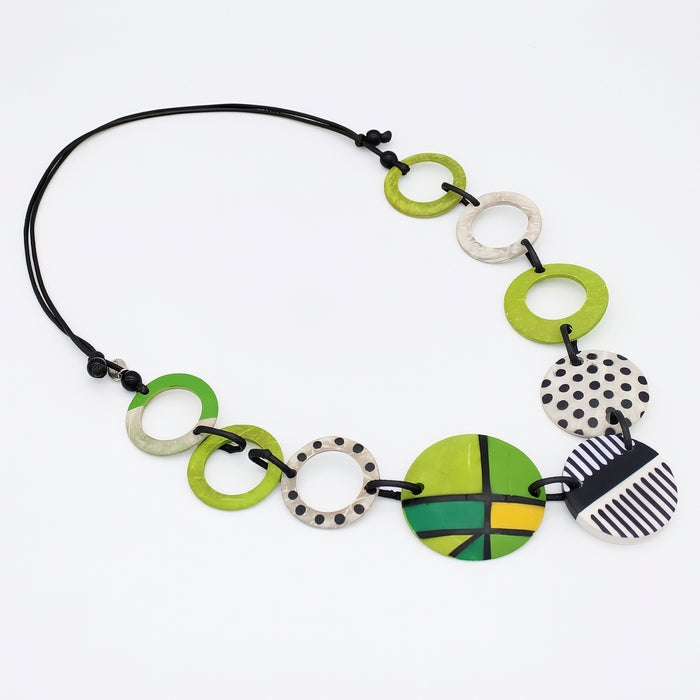 Necklace with colorful  and polka dot circular beads on a white background
