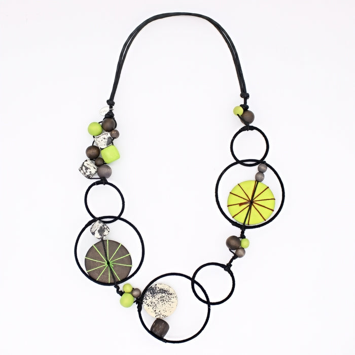 Necklace with circular beads and green accents on a white background