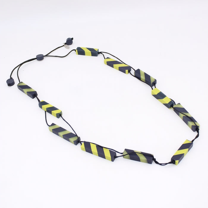 Necklace with black and yellow striped beads on a white background