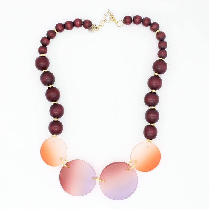 Necklace with wooden and gradient beads on a white background