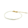 A dainty children's bracelet with white rice freshwater pearls and a gold vermeil clasp.