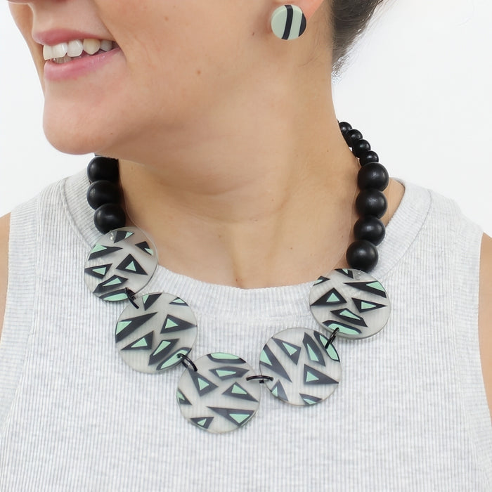 Model wearing mint black and ivory geometric statement necklace