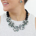 Model wearing mint black and ivory geometric statement necklace