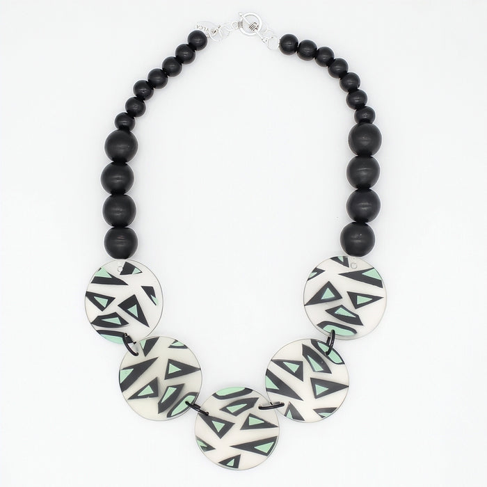 Mint geometric statement necklace with black wood beads on white background