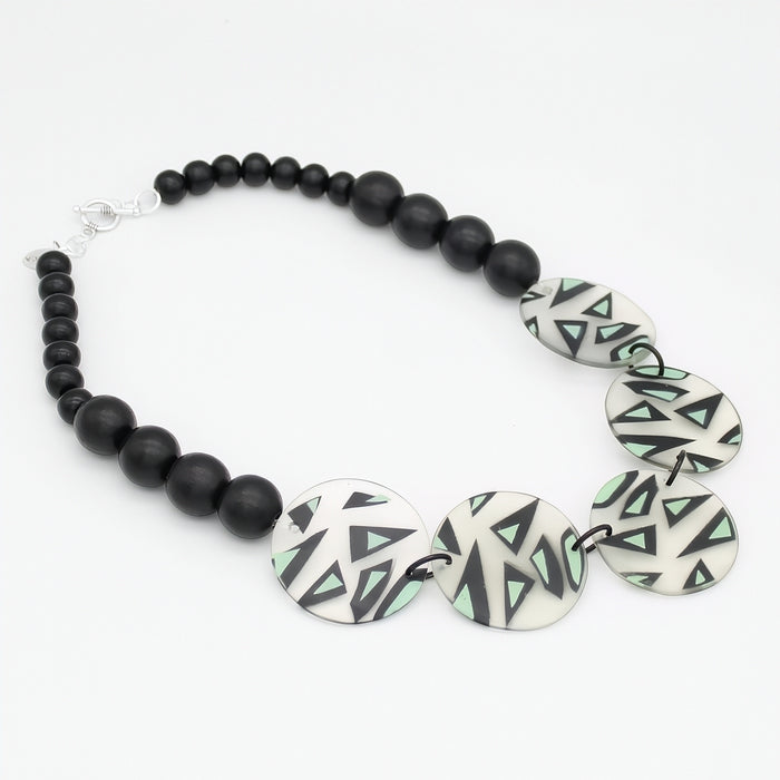 Mint black and ivory geometric statement necklace flat lay