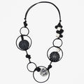 Necklace with black and white circular beads on a white background